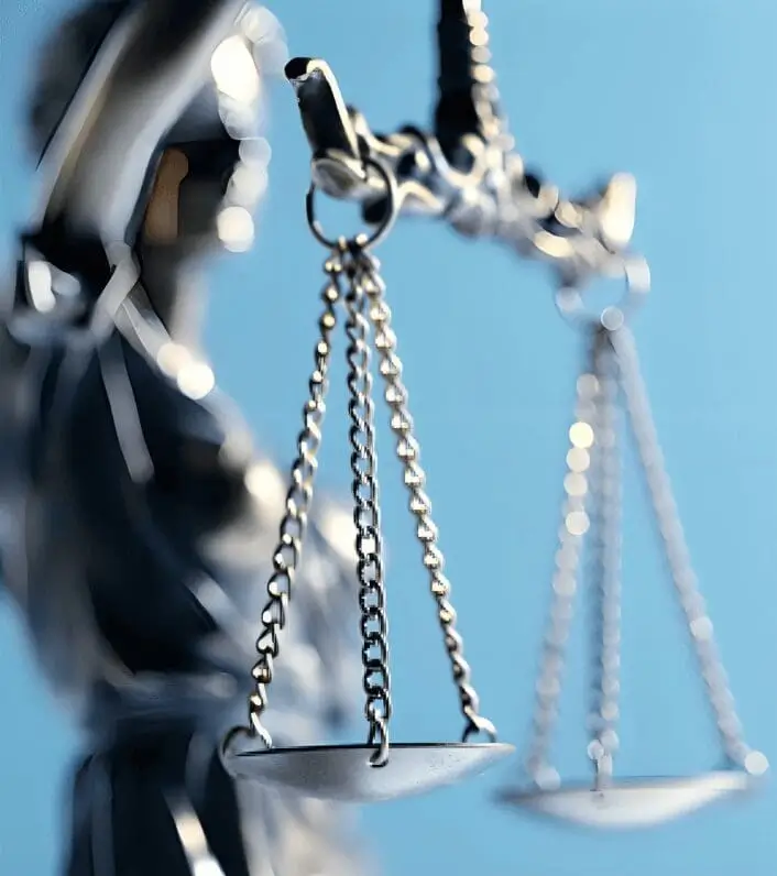 Scales of justice with blue background.