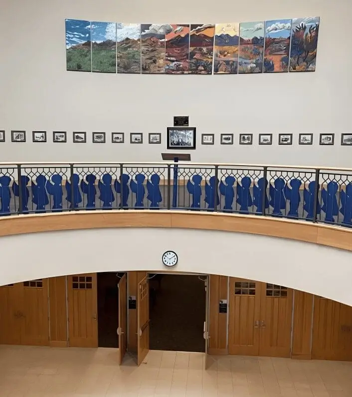 Art gallery with paintings and wooden doors.