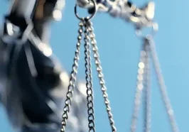 Close-up of silver balance scale against blue