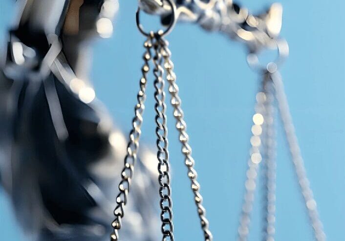 Hanging scale pans and chains with blue backdrop