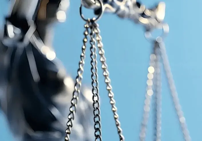 Close-up of silver balance scale against blue